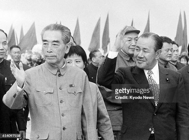 Japan - File photo taken in September 1972 shows Japanese Prime Minister Kakuei Tanaka waving at people seeing him off at Shanghai airport, with...