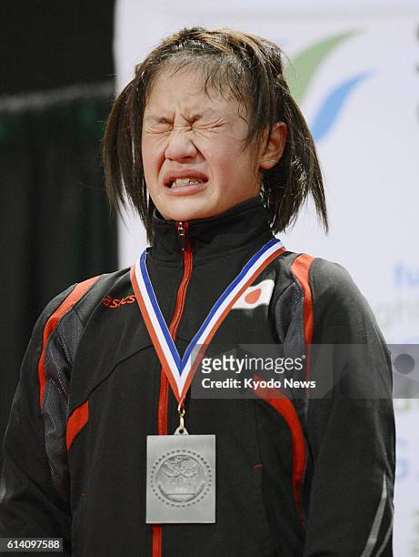 Canada - Japan's Eri Tosaka with a silver medal sheds tears at the awards ceremony after being defeated by Vanesa Kaladzinskaya of Belarus in the...