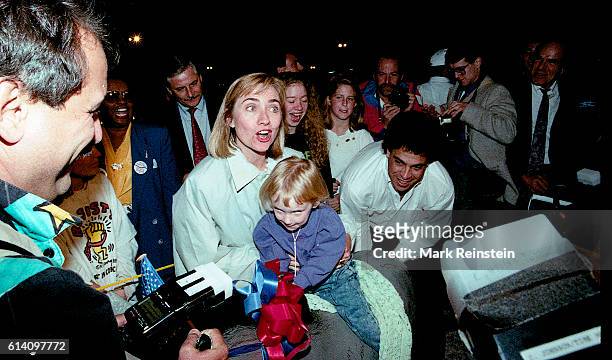On her birthday, future US First Lady Hillary Clinton poses with a papier-mache donkey , ridden by an unidentified young girl, during a stop at Elon...