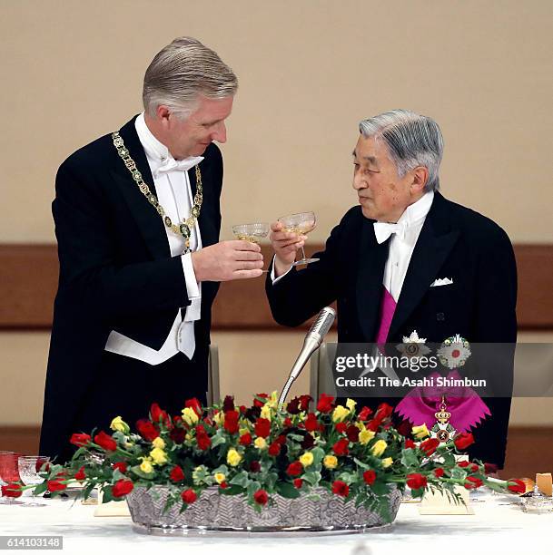 Emperor Akihito and King Philippe of Belgium toast their glasses during the state dinner at the Imperial Palace on October 11, 2016 in Tokyo, Japan.