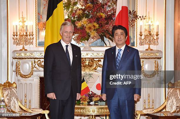 Belgium's King Philippe and Japan's Prime Minister Shinzo Abe pose for the media before their talks at the state guest house in Tokyo on October 12,...