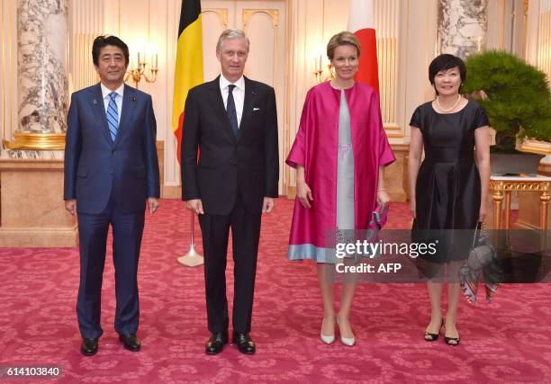 Belgium's King Philippe and Queen Mathilde are escorted by Japan's Prime Minister Shinzo Abe and his wife Akie at the state guest house in Tokyo on...