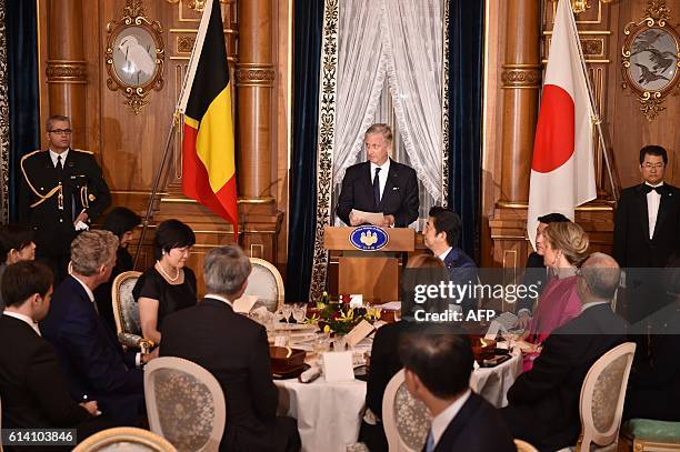 Belgium's King Philippe delivers a speech at the opening of a dinner hosted by Japan's Prime Minister Shinzo Abe at the state guest house in Tokyo on...