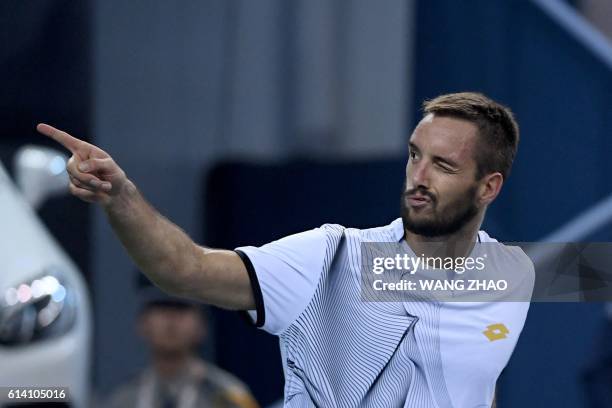 Viktor Troicki of Serbia celebrates after winning against Rafael Nadal of Spain during their men's singles match at the Shanghai Masters tennis...