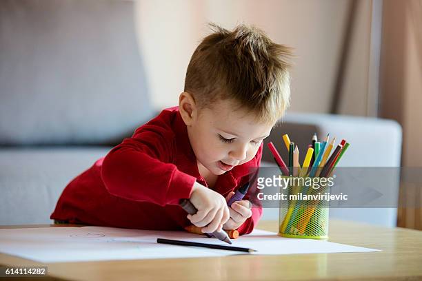 happy little boy coloring - craft table stock pictures, royalty-free photos & images