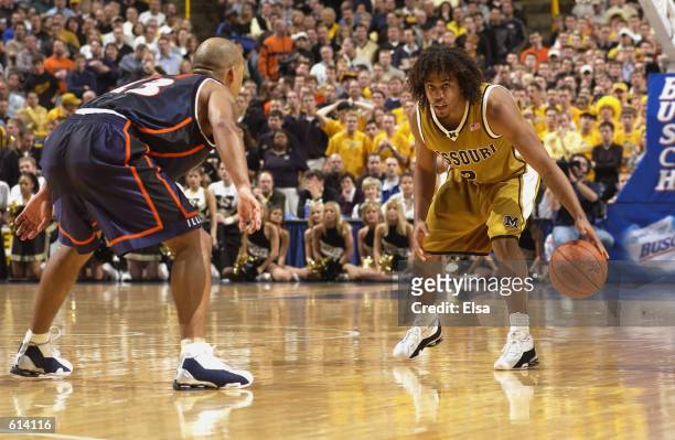 Wesley Stokes of the Missouri Tigers is defended by Cory Bradford of the Illinois Fighting Illini during the game at the the Savvis Center in St....