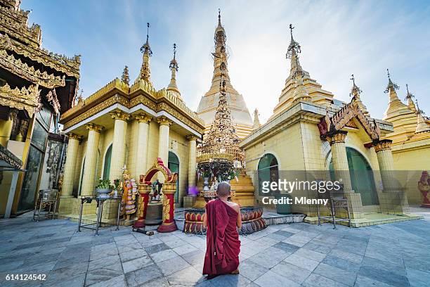 burmese monk praying at sule pagoda myanmar - sule pagoda stock pictures, royalty-free photos & images