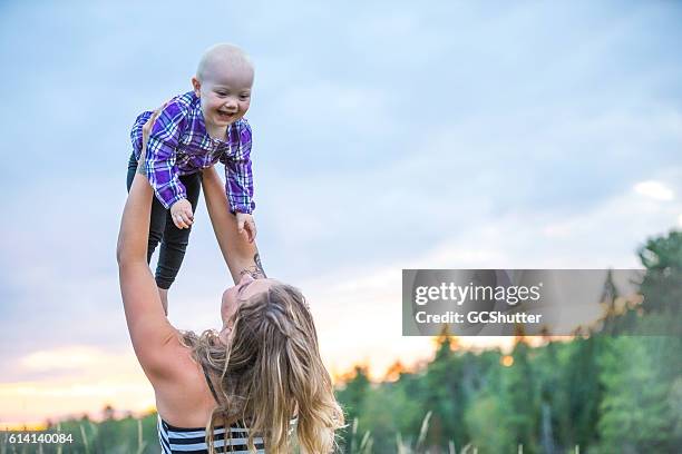 mum hold me high, it is so much fun - toned image stock pictures, royalty-free photos & images