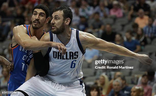 Enes Kanter of the Oklahoma City Thunder and Andrew Bogut of the Dallas Mavericks battle during a preseason game at American Airlines Center on...