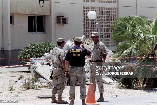 Investigators inspect on June 29, 1996 the site of the truck bomb that exploded on June 21 outside a US military personnel housing complex in Khobar...