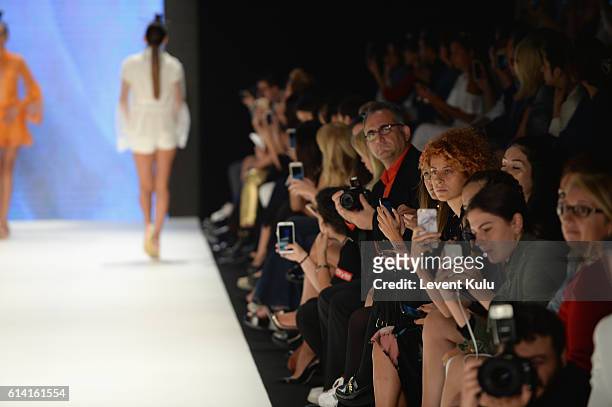 Guests sit by the runway at the Selma State show during Mercedes-Benz Fashion Week Istanbul at Zorlu Center on October 12, 2016 in Istanbul, Turkey.