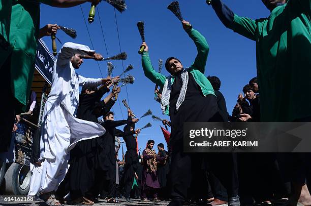 Afghan Shiite Muslims use chains during ritual self-flagellation as part of Ashura commemorations in Herat on October 12, 2016. Ashura is a period of...