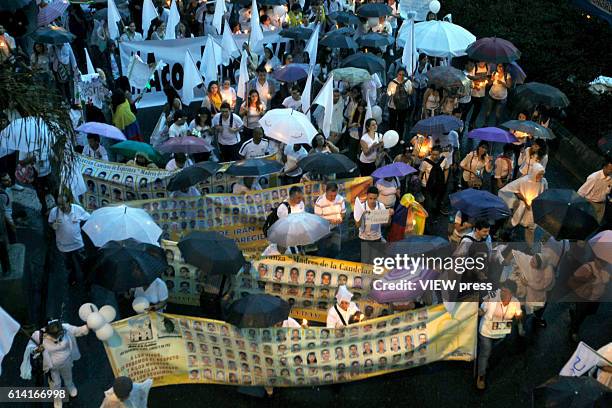 People take part in a march supporting the peace process on October 7, 2016 in Medellin, Colombia.