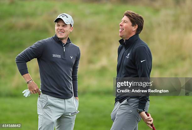 Danny Willett of England and former footballer Darren Anderton share a joke during the Hero Pro-Am at The Grove on October 12, 2016 in Watford,...