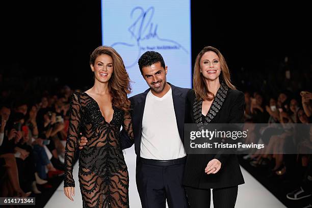 Model Tulin Sahin, designer Rasit Bagzibagli and Demet Sener walk the runway at the Rasit Bagzibagli show during Mercedes-Benz Fashion Week Istanbul...