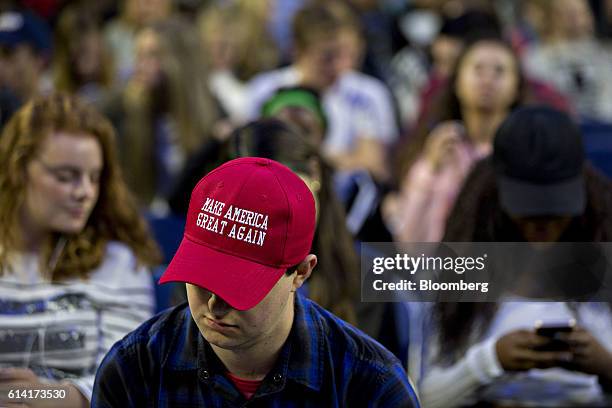 Student wears a "Make America Great Again" campaign hat before Mike Pence, 2016 Republican vice presidential nominee, not pictured, speaks at a...