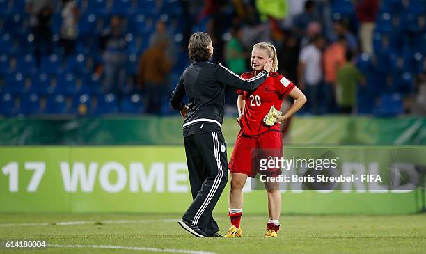 Head Coach Anouschka Bernhard of Germany comforts Lisa Schoeppl of Germany after losing the FIFA U-17 Women's World Cup Quarter Final match between...