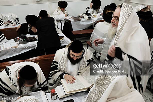 Members of an Orthodox Jewish community study the Torah in Williamsburg, Brooklyn on Yom Kippur, one of the most important holidays of the Jewish...