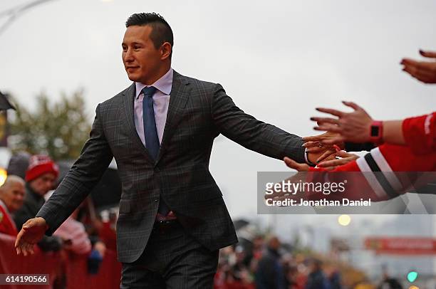Jordin Tootoo of the Chicago Blackhawks greets fans during a red-carpet even before the season opening gameagainst the St. Louis Blues at the United...