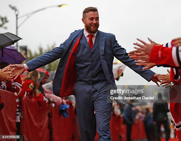 Scott Darling of the Chicago Blackhawks greets fans during a red-carpet even before the season opening gameagainst the St. Louis Blues at the United...