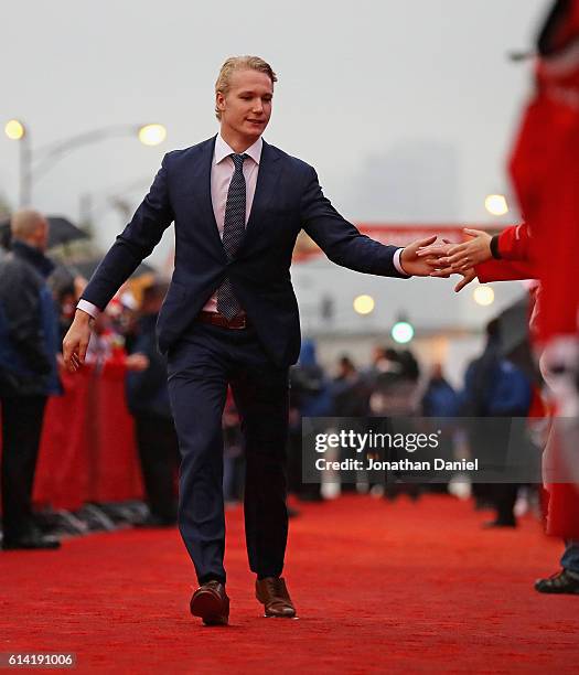 Gustav Forsling of the Chicago Blackhawks greets fans during a red-carpet even before the season opening gameagainst the St. Louis Blues at the...