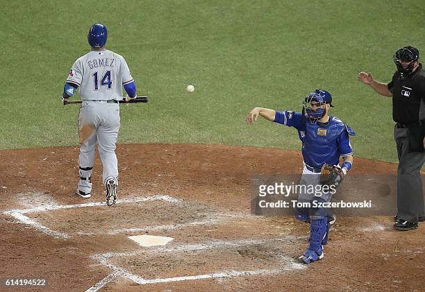 Carlos Gomez of the Texas Rangers reacts after striking out in the tenth inning during MLB game action as Russell Martin of the Toronto Blue Jays...
