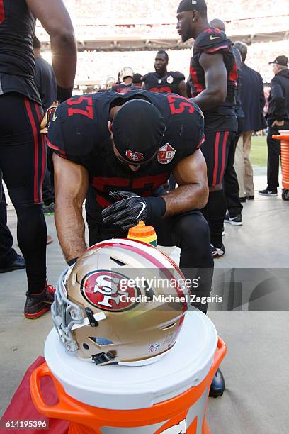 Michael Wilhoite of the San Francisco 49ers says a prayer on the sideline prior to the game against the Arizona Cardinals at Levi Stadium on October...