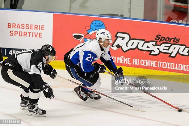 Mathieu Joseph of the Saint John Sea Dogs skates the puck against Jeremy Roy of the Blainville-Boisbriand Armada during the QMJHL game at the Centre...