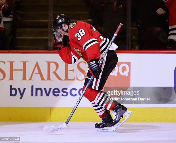 Ryan Hartman of the Chicago Blackhawks celebrates his first NHL goal in the second period against the St. Louis Blues during the season opening game...