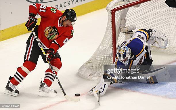 Jake Allen of the St. Louis Blues makes a save against Marian Hossa of the Chicago Blackhawks in the third period during the season opening game at...