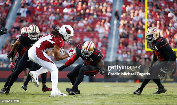 Michael Wilhoite, Jaquiski Tartt and Tank Carradine of the San Francisco 49ers close in on Larry Fitzgerald of the Arizona Cardinals during the game...