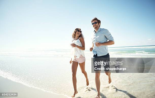 too busy making memories - couple on beach sunglasses stock pictures, royalty-free photos & images