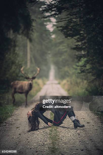 msystic scene with a women and a deer in forest - long green dress stock pictures, royalty-free photos & images