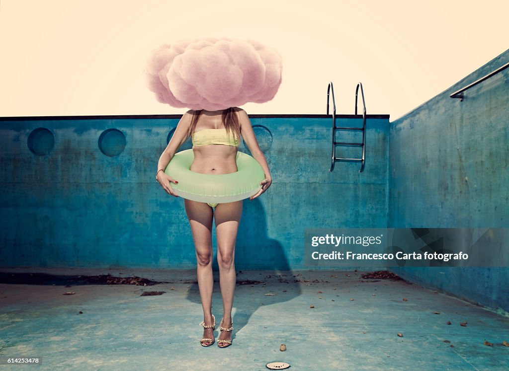 Woman in empty swimming pool