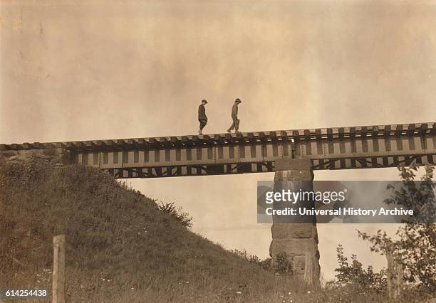 Two Young Boys Walking Along Elevated Train Track, Westfield, Massachusetts, USA, circa 1916.