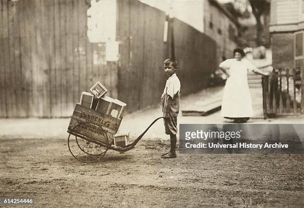Young Boy Delivering Boxes with Push Cart, Roxbury, Massachusetts, USA, circa 1912.
