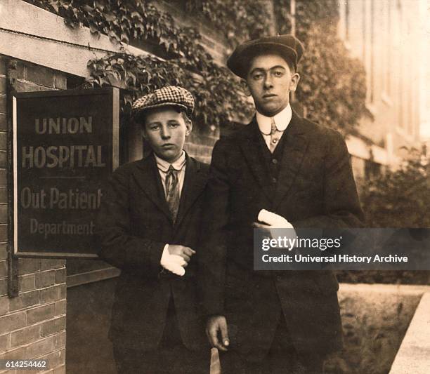 Portrait of Two 14-year-old Boys, Oscar Matoon and John Healy, with Hand Injuries Sustained while Working at Textile Mills, Fall River,...