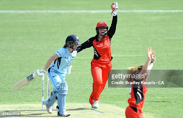 Sarah Coyte and Tegan McPharlin of South Australia celebrate taking the wicket of Nicola Carey of NSW during the WNCL match between New South Wales...