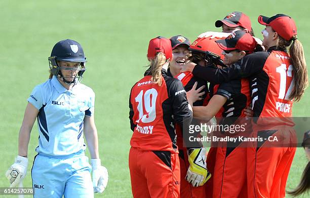 Sarah Coyte of South Australia celebrates with team mates after taking the wicket of Nicola Carey of NSW during the WNCL match between New South...