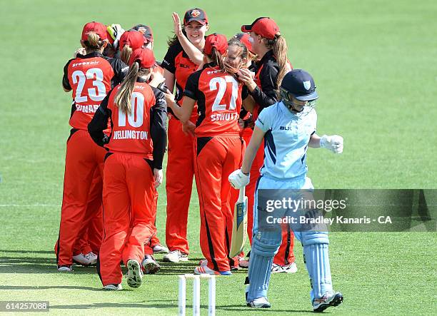 Sarah Coyte of South Australia celebrates with team mates after taking the wicket of Nicola Carey of NSW during the WNCL match between New South...