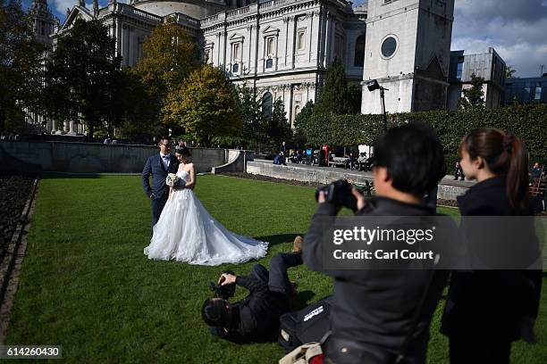 Echo Li and her fiance Charles Qian, pose during a pre-wedding photography shoot at St Paul's Cathedral, on October 11, 2016 in London, England. It's...