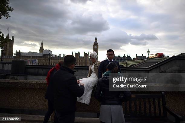 Charles Qian and his fiance Echo Li prepare for a pre-wedding photography shoot opposite the Palace of Westminster on October 11, 2016 in London,...