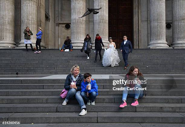 Echo Li and her fiance Charles Qian, descend the steps of St Paul's Cathedral during a pre-wedding photography shoot, on October 11, 2016 in London,...