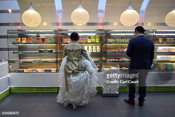 Bride-to-be, Echo Li and her fiance Charles Qian, choose lunch as they take a break during a pre-wedding photography shoot on October 11, 2016 in...