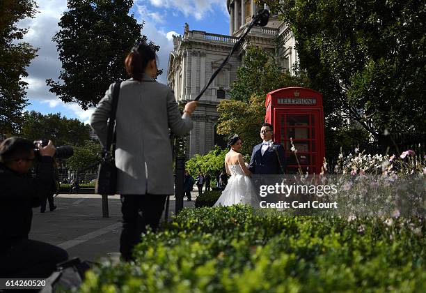 Echo Li and her fiance Charles Qian, pose during a pre-wedding photography shoot next to St Paul's Cathedral, on October 11, 2016 in London, England....