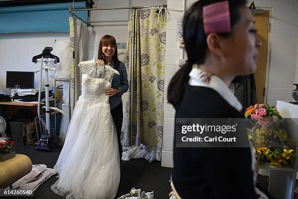 Dress assistant Susan Su prepares a wedding dress chosen by Echo Li as preparations are made for Echo and her fiance Charles Qian, both from Shenzhen...