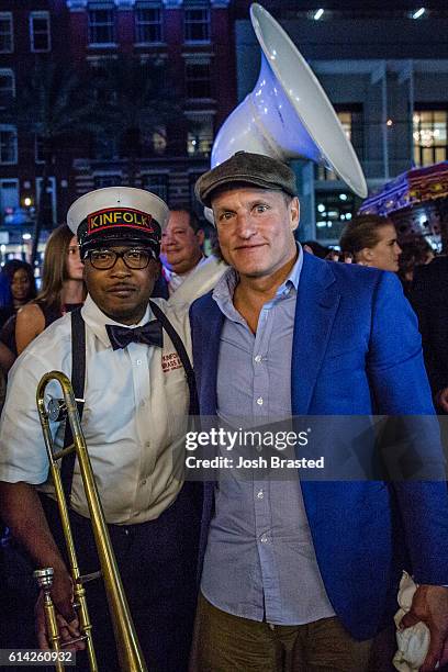 Woody Harrelson poses with members of the Kinfolk Brass Band at a second line parade following the New Orleans premiere of 'LBJ' at The Orpheum...