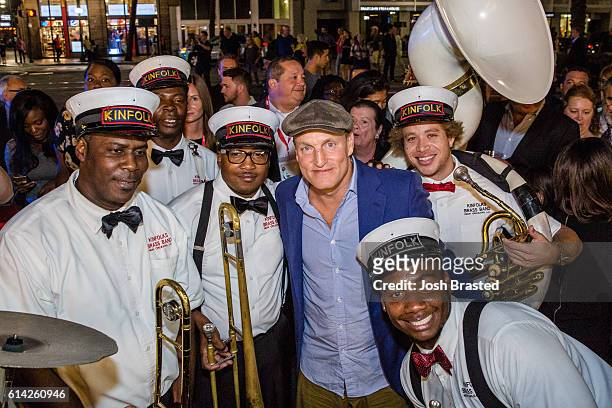 Woody Harrelson poses with members of the Kinfolk Brass Band at a second line parade following the New Orleans premiere of 'LBJ' at The Orpheum...