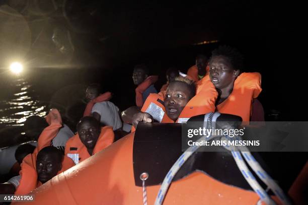 Migrants and refugees are rescued after the rubber boat they were in began to take on water some eight nautical miles off Libya's Mediterranean...