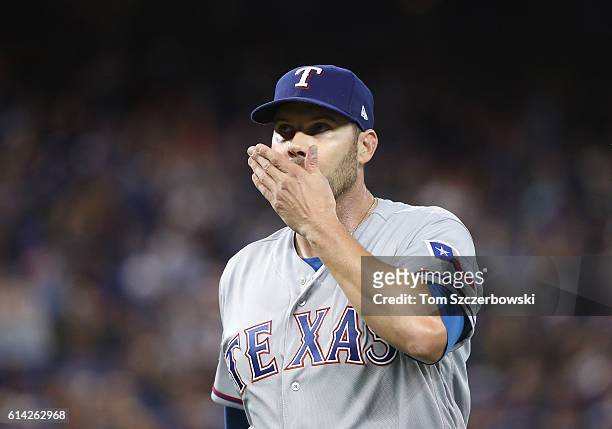 Colby Lewis of the Texas Rangers reacts as he exits the game after being relieved in the third inning during MLB game action against the Toronto Blue...